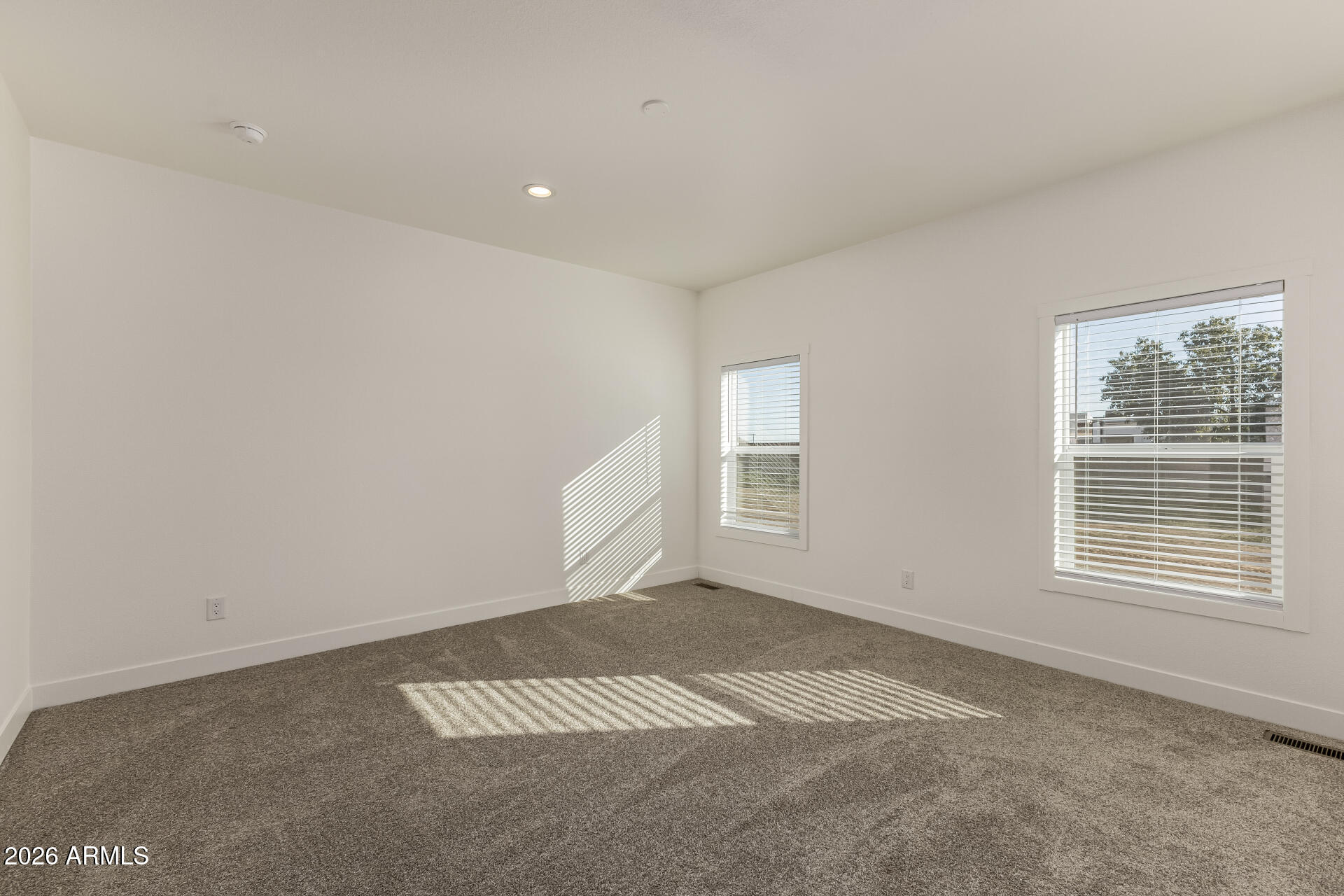 23059 West Rancho Laredo Drive Wittmann, AZ 85361 - Photo 9 of 29 an empty room with windows