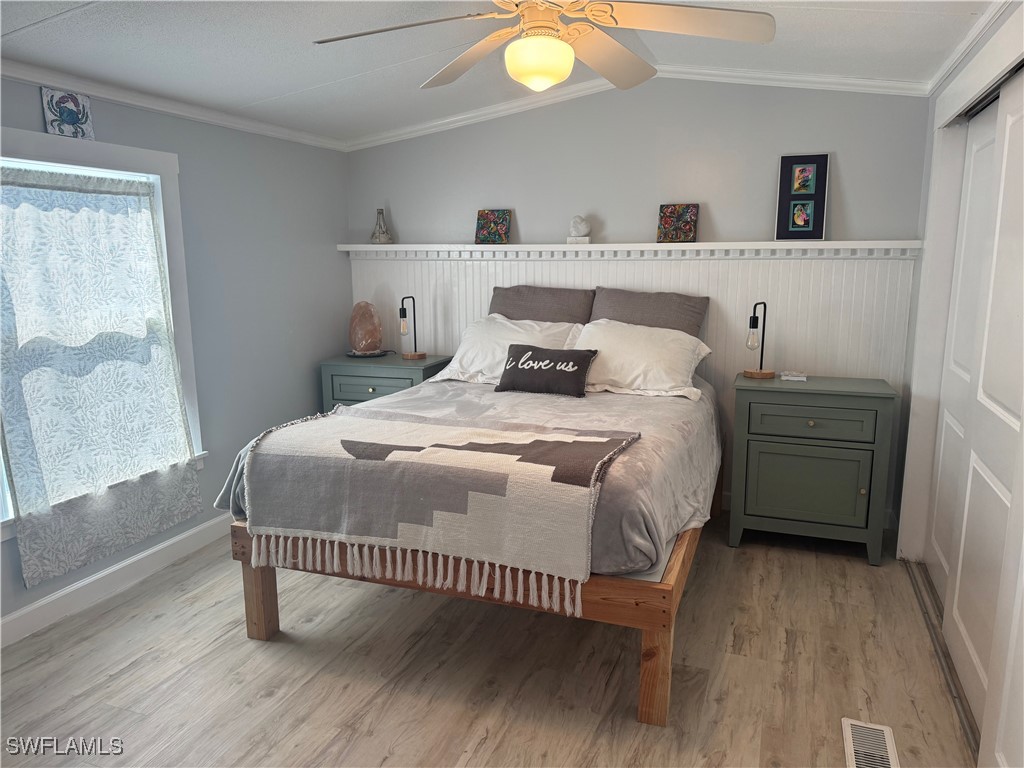 3813 Dewberry Lane St. James City, FL 33956 - Photo 4 of 9 a bedroom with a bed and a window