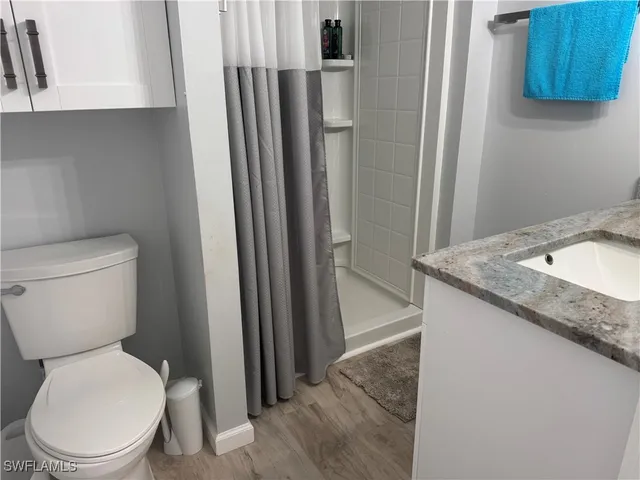 a white toilet sitting next to a bathroom sink