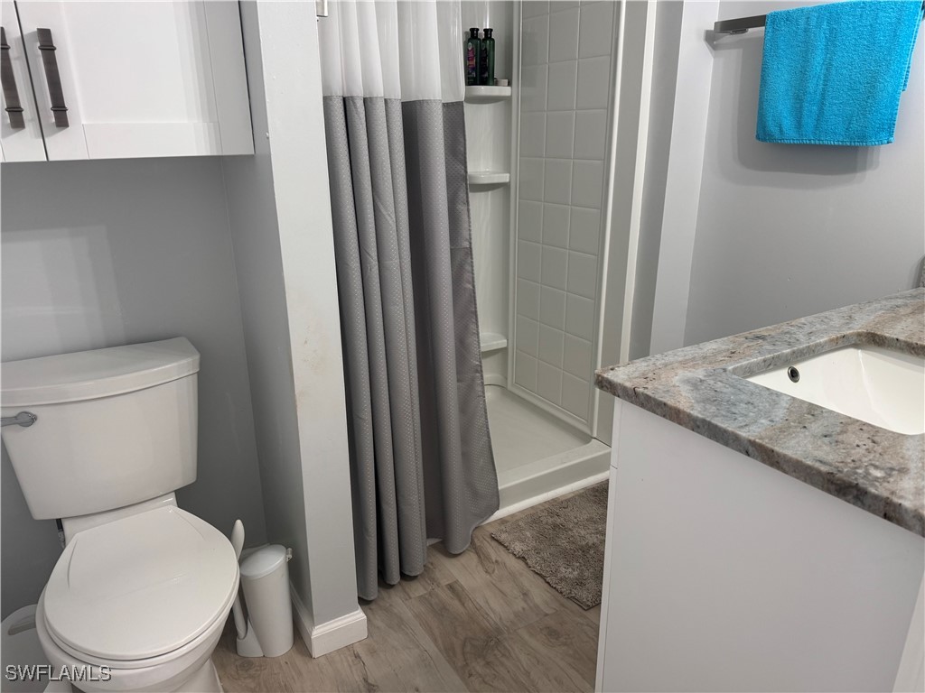 3813 Dewberry Lane St. James City, FL 33956 - Photo 5 of 9 a white toilet sitting next to a bathroom sink