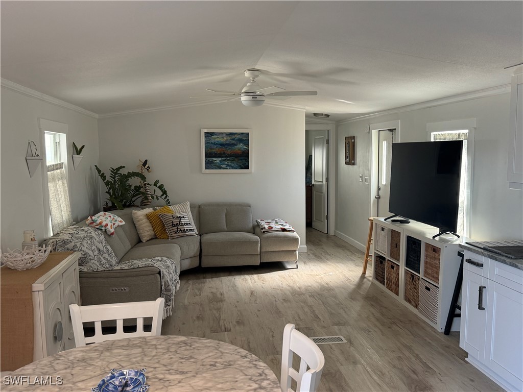3813 Dewberry Lane St. James City, FL 33956 - Photo 9 of 9 a living room with furniture and a flat screen tv