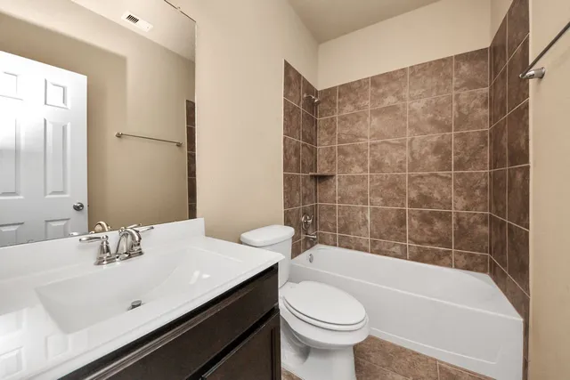 a bathroom with a sink a toilet and bathtub