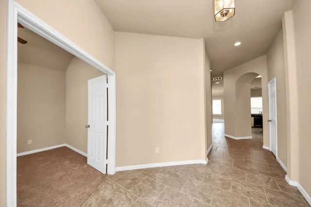 a view of a hallway with wooden shelves
