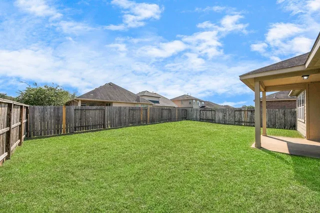 a view of a backyard with a garden and deck