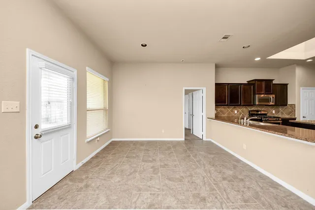 a view of a kitchen with a sink and a refrigerator