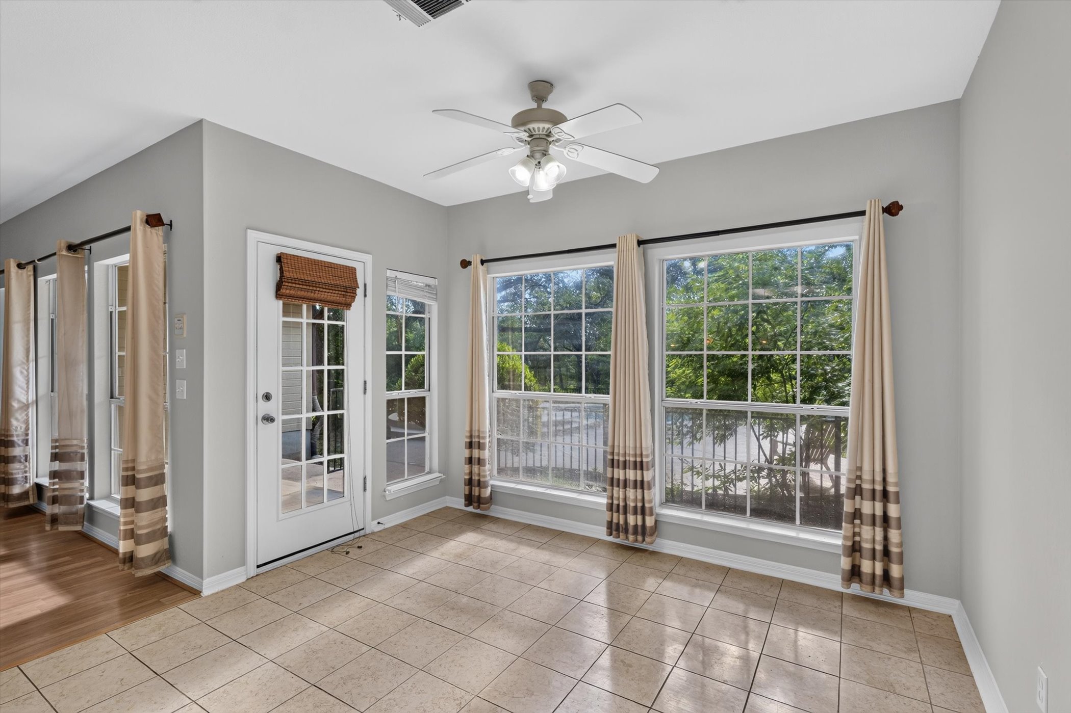13615 Copperleaf Trail Manchaca, TX 78652 - Photo 19 of 38 A cheerful room with ample natural light from large windows, featuring easy-to-maintain tile flooring.