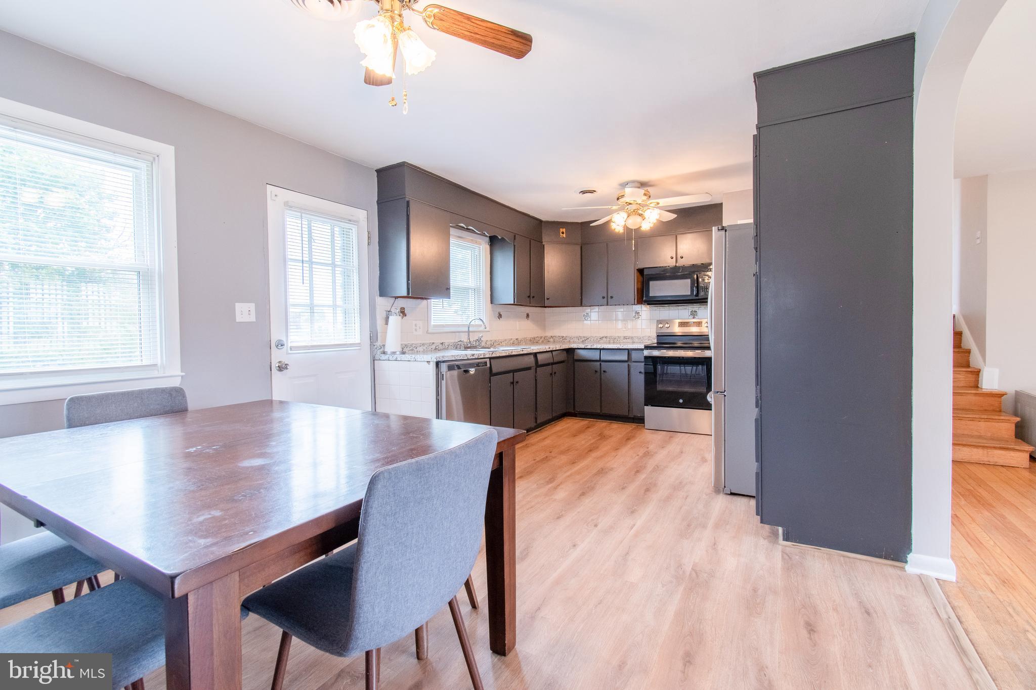 3911 Sunset Drive Hampstead, MD 21074 - Photo 16 of 38 a kitchen with kitchen island a sink table and chairs