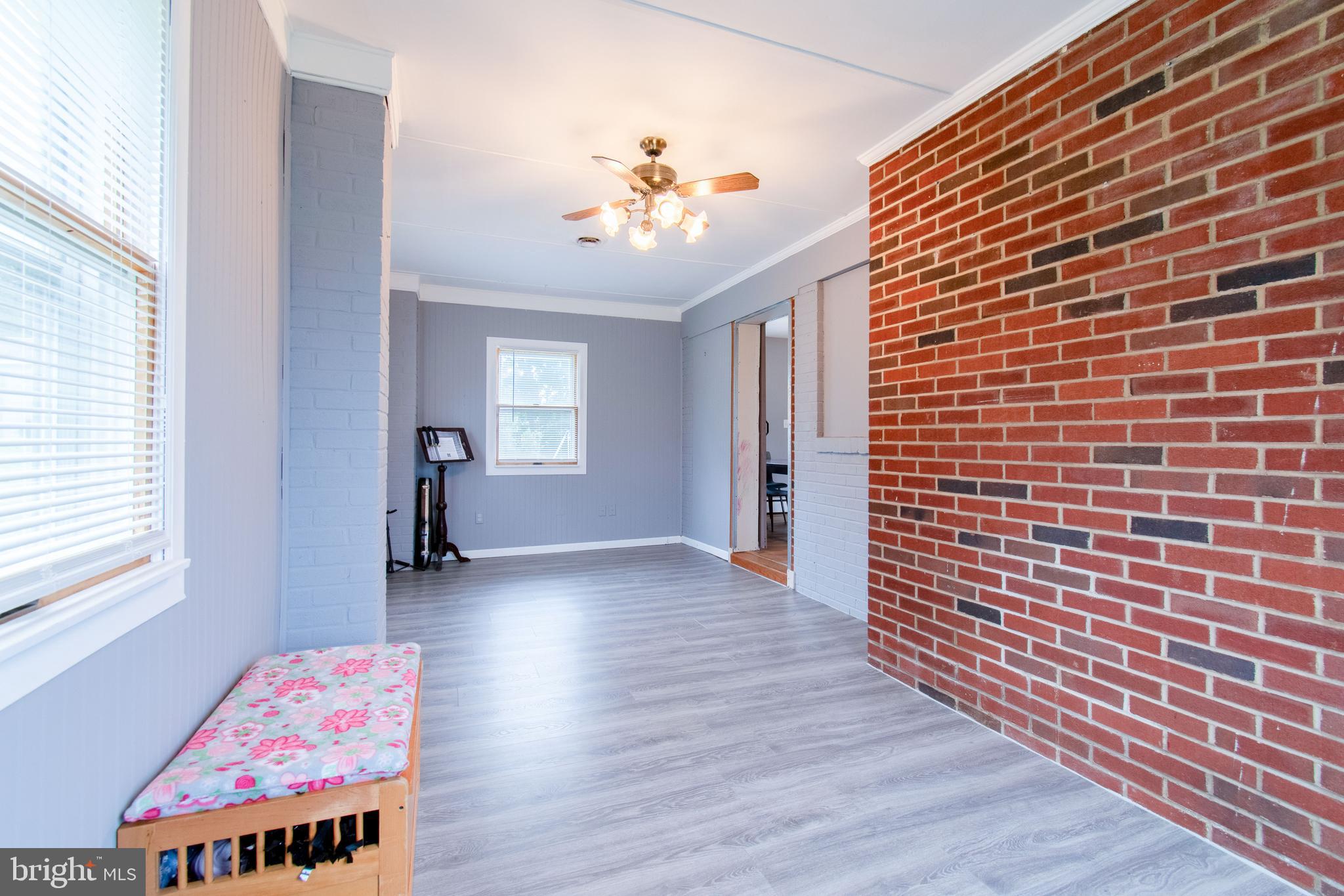 3911 Sunset Drive Hampstead, MD 21074 - Photo 19 of 38 a view of an empty room with a window and wooden floor
