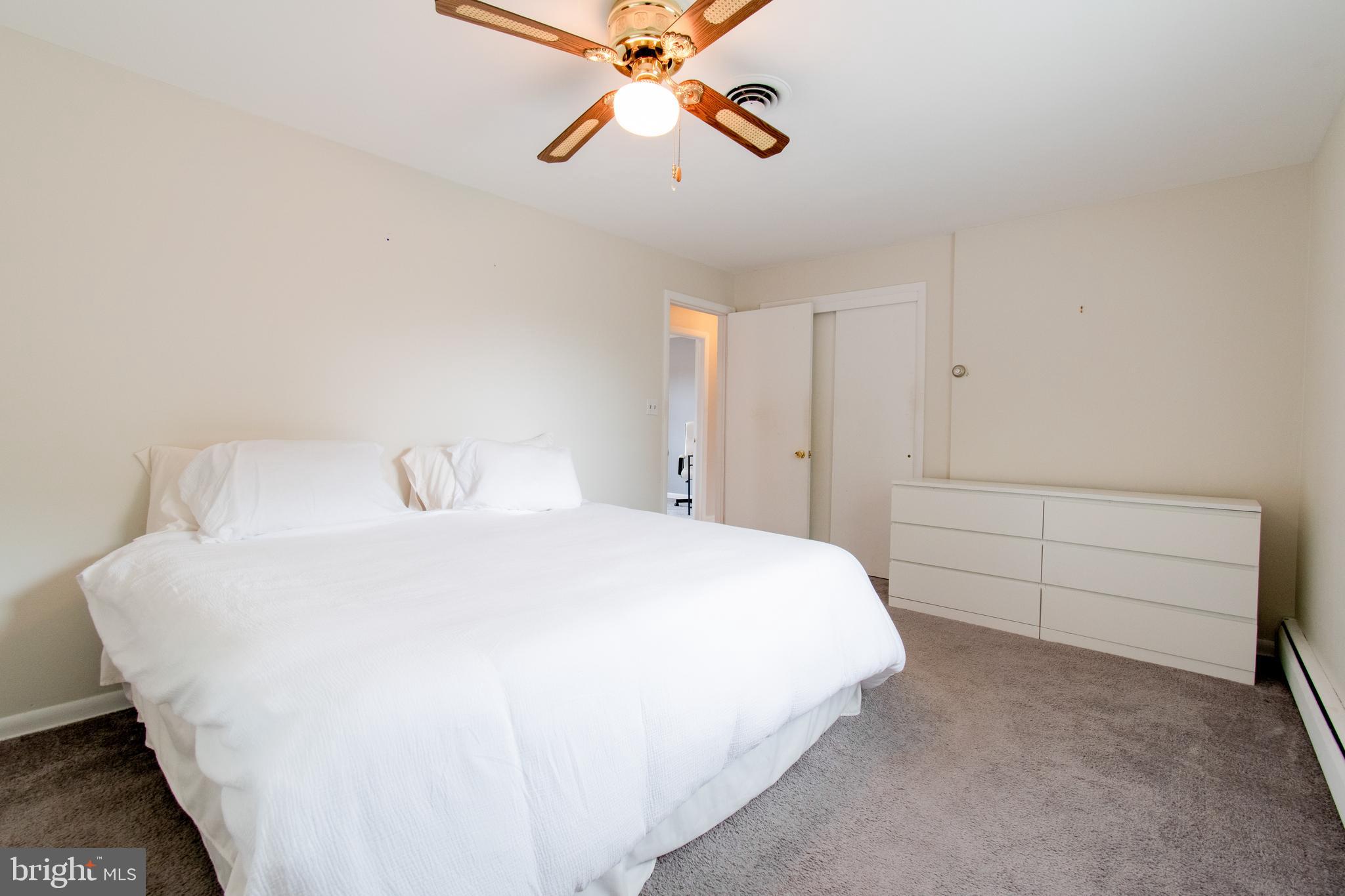 3911 Sunset Drive Hampstead, MD 21074 - Photo 21 of 38 a bedroom with a bed and a chandelier