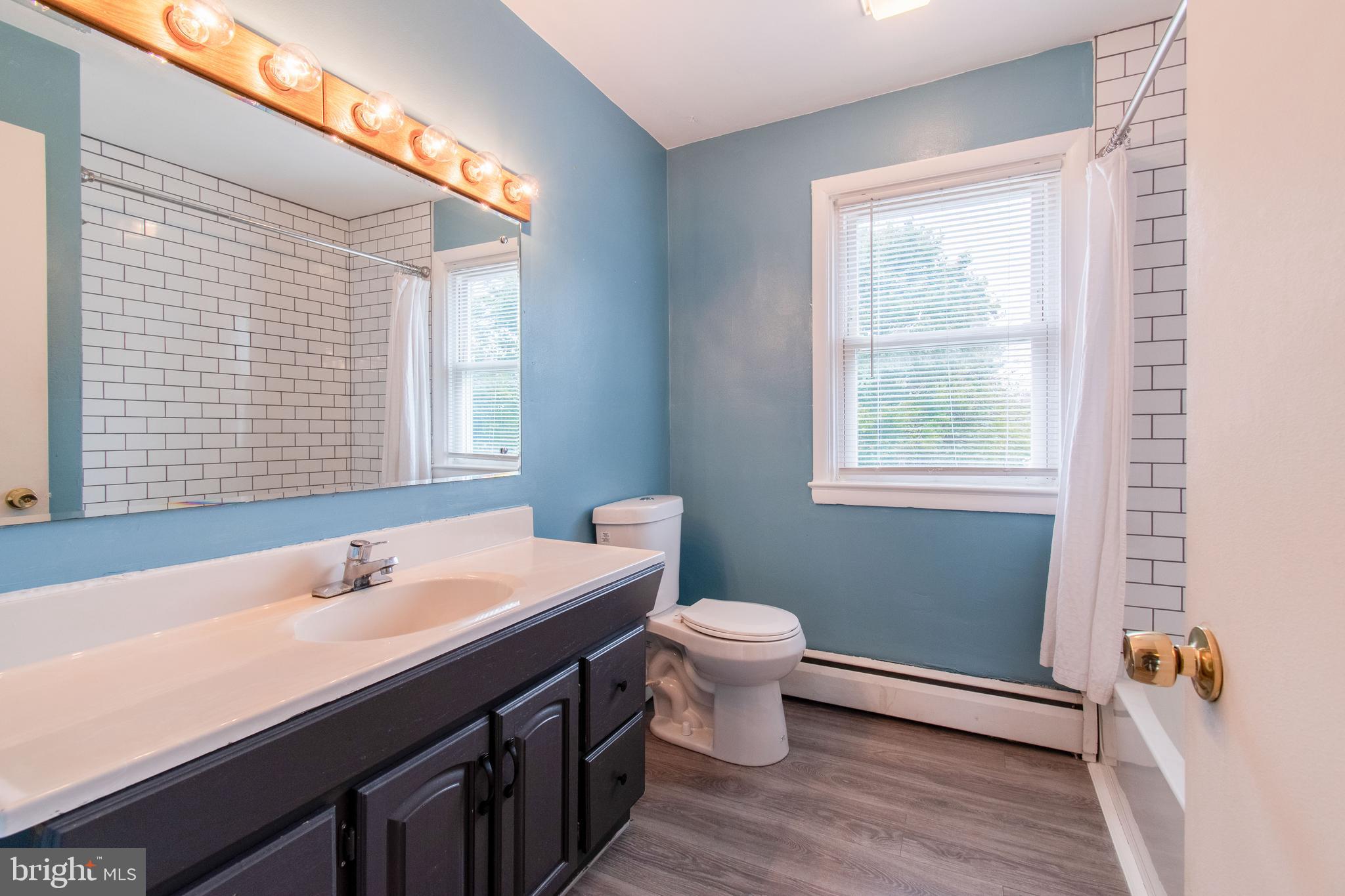 3911 Sunset Drive Hampstead, MD 21074 - Photo 24 of 38 a bathroom with a sink a toilet and a window