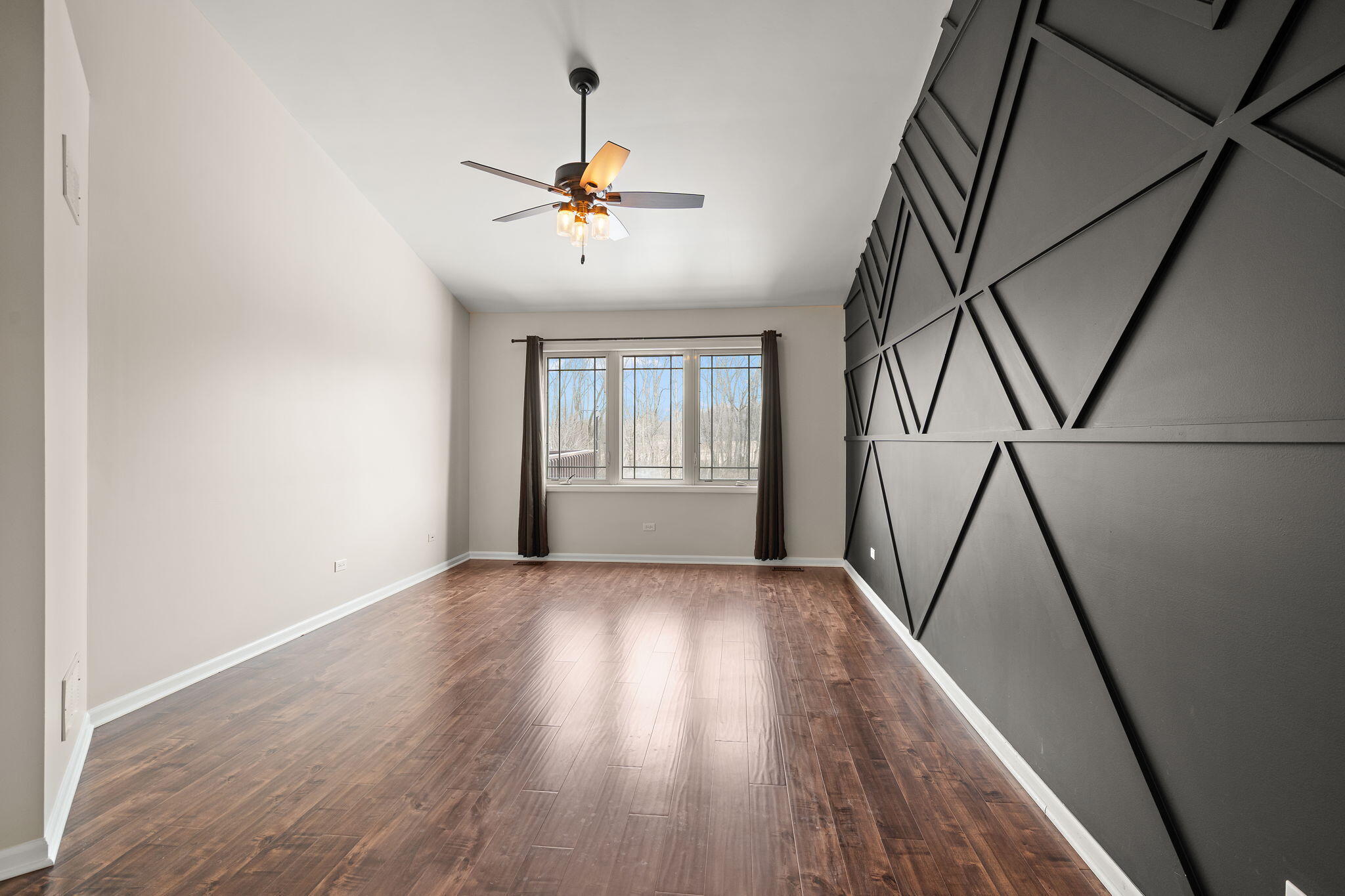 15976 97th Court Dyer, IN 46311 - Photo 12 of 29 a view of empty room with wooden floor and fan