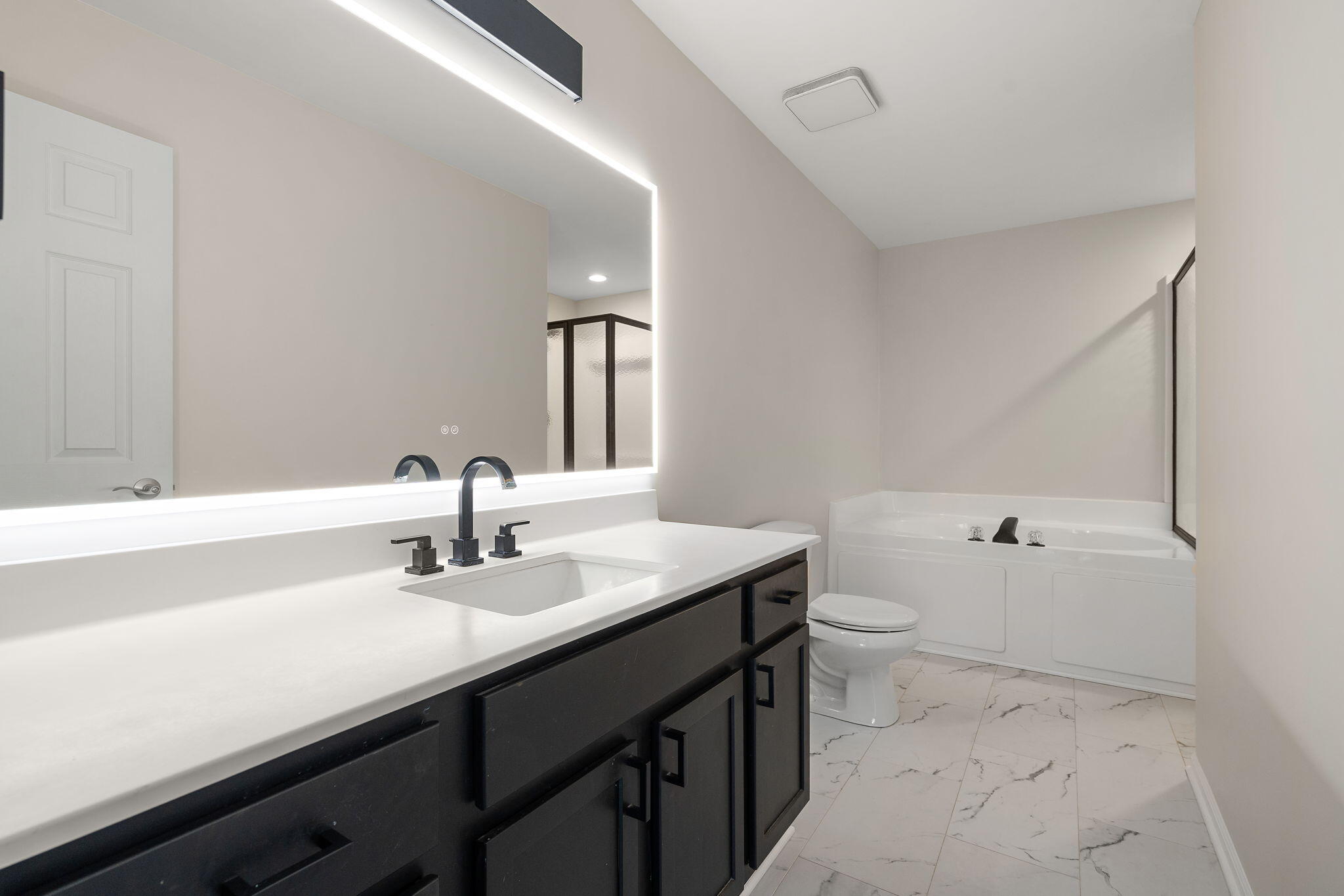 15976 97th Court Dyer, IN 46311 - Photo 14 of 29 a bathroom with a sink a toilet and mirror
