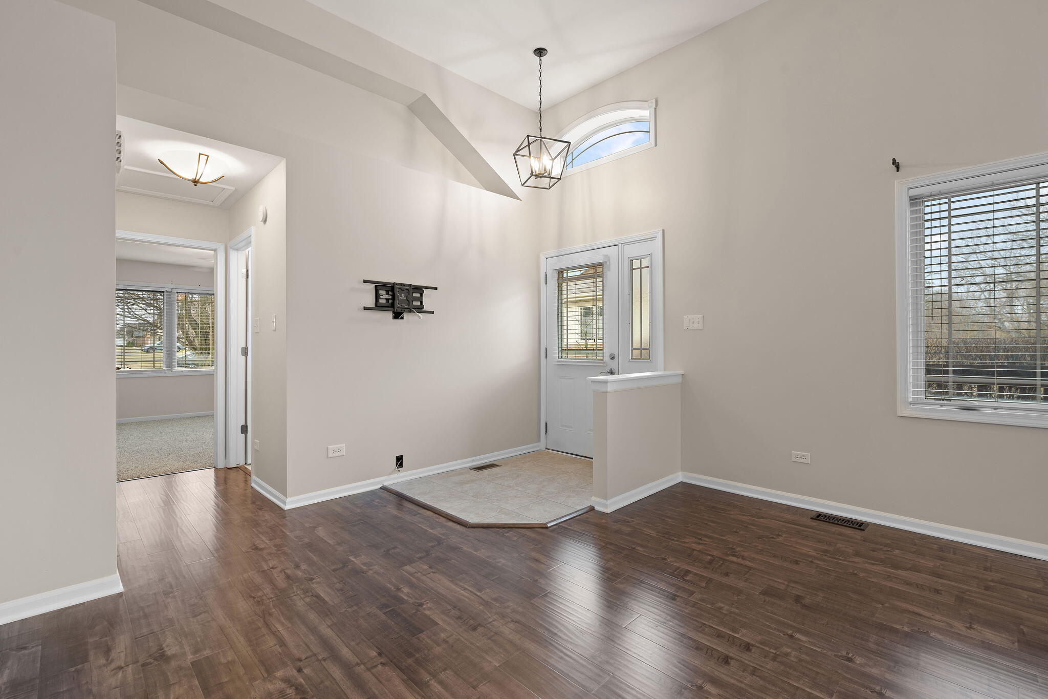15976 97th Court Dyer, IN 46311 - Photo 2 of 29 wooden floor in an empty room with a window