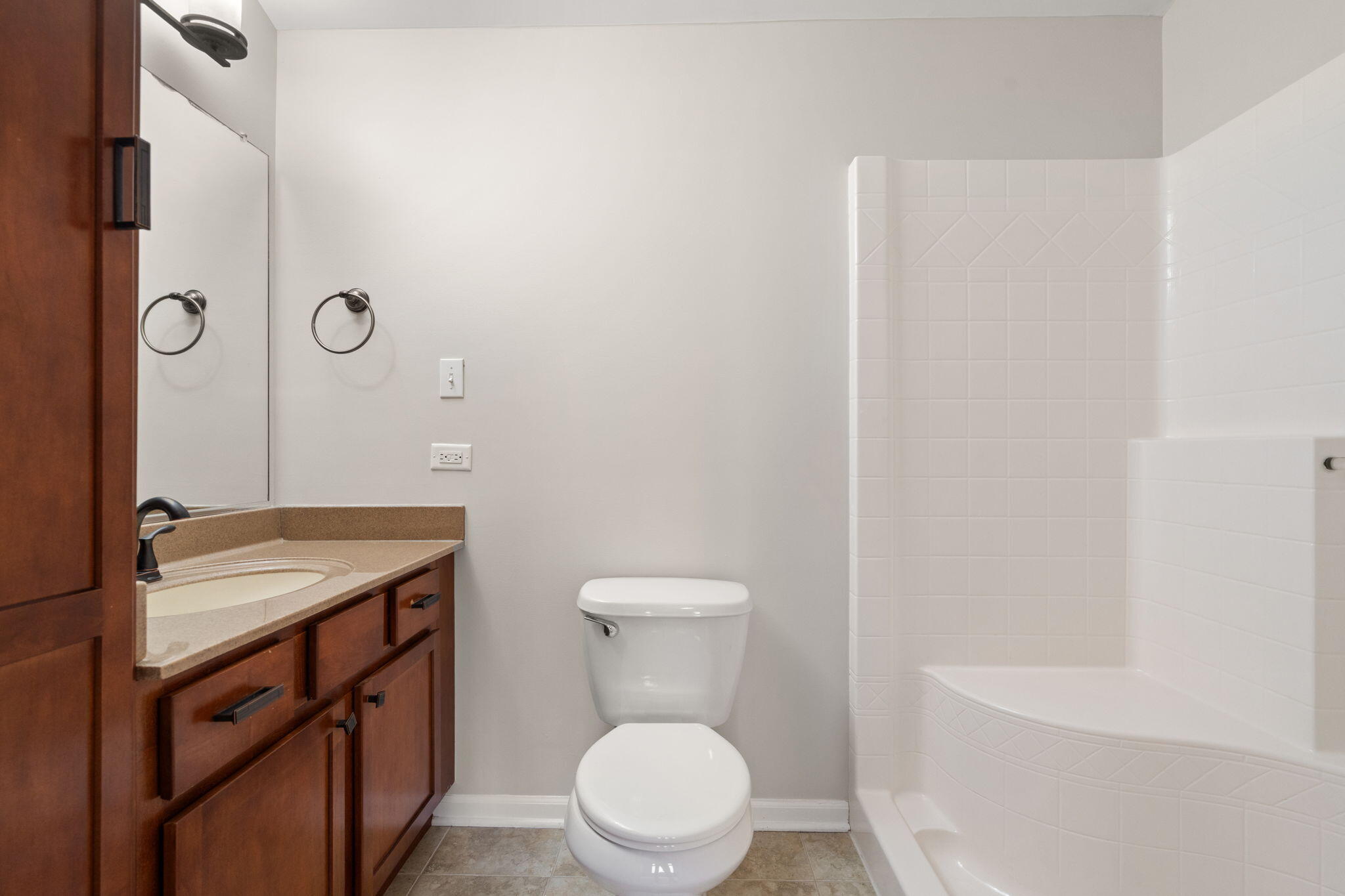 15976 97th Court Dyer, IN 46311 - Photo 21 of 29 a bathroom with a granite countertop toilet a sink and a mirror
