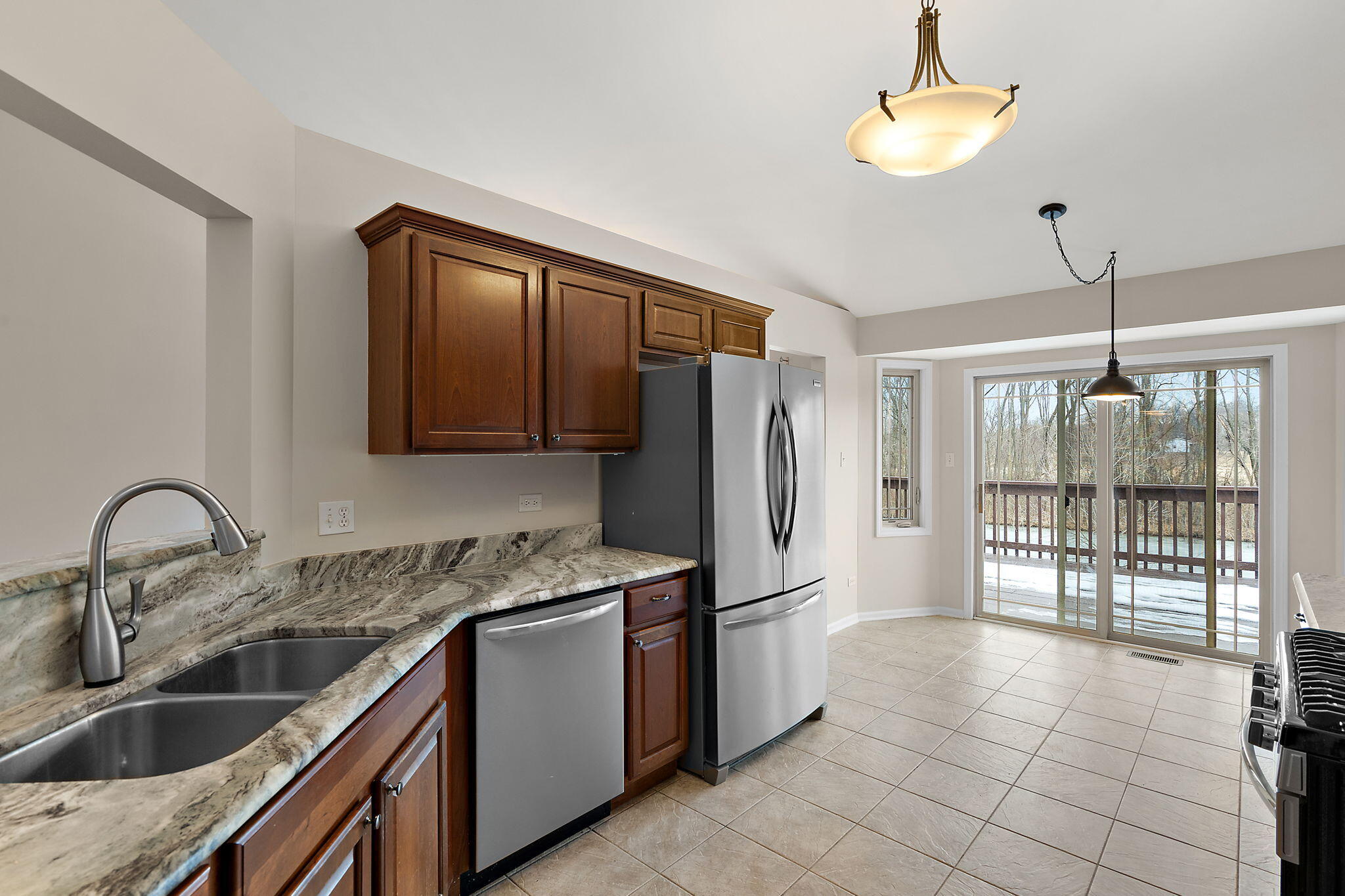 15976 97th Court Dyer, IN 46311 - Photo 7 of 29 a kitchen with a refrigerator sink and cabinets