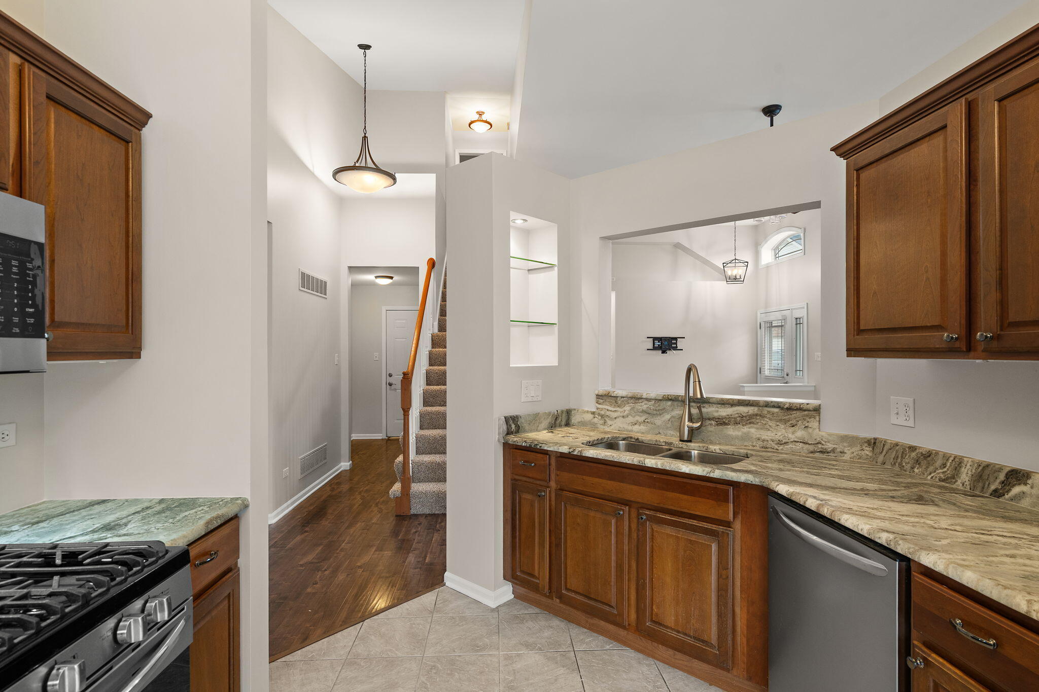 15976 97th Court Dyer, IN 46311 - Photo 8 of 29 a kitchen with granite countertop a sink stove and refrigerator
