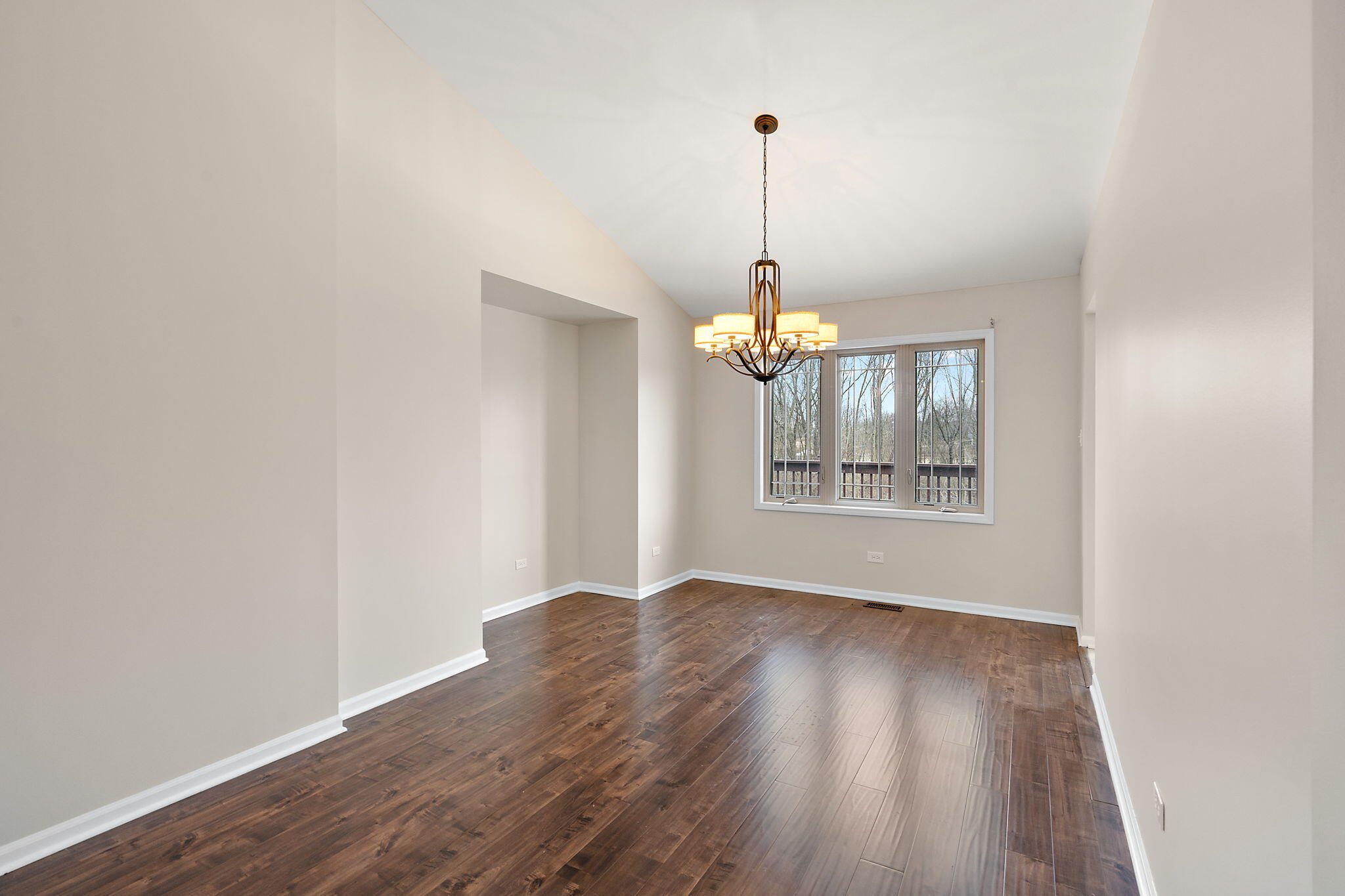15976 97th Court Dyer, IN 46311 - Photo 10 of 29 a view of an empty room with a window and wooden floor