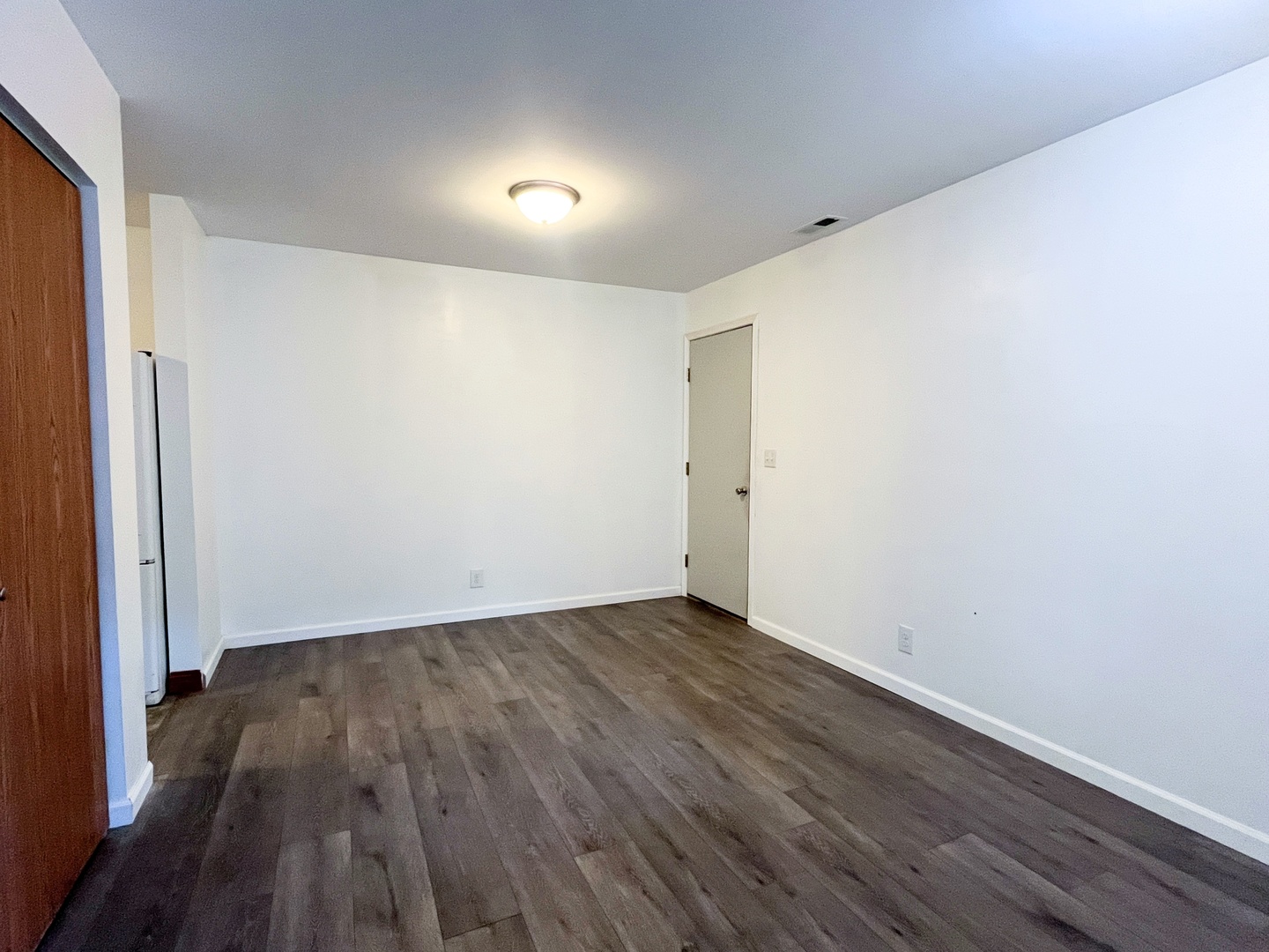 340 North Wooster Street Capron, IL 61012 - Photo 11 of 32 a view of an empty room with wooden floor and a window