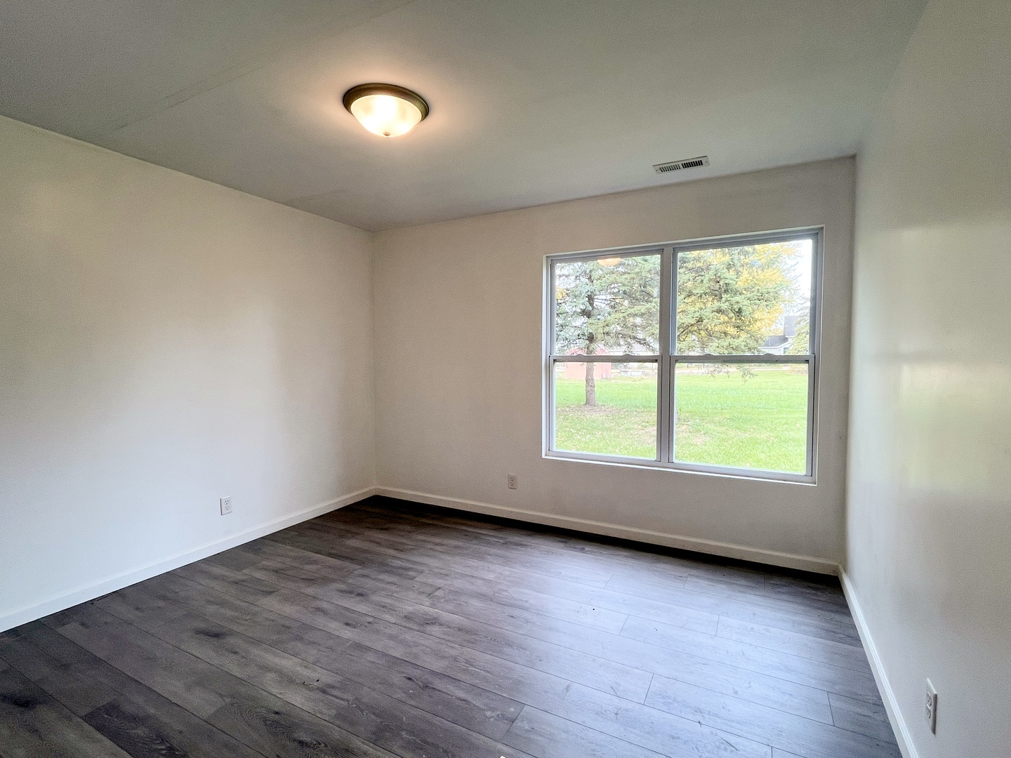 340 North Wooster Street Capron, IL 61012 - Photo 12 of 32 an empty room with wooden floor and windows