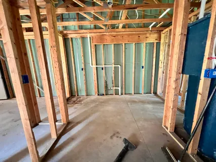 a picture of a room with a white wall and a large window