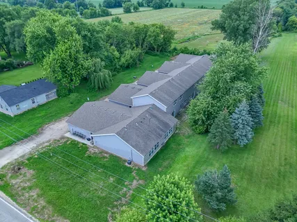 an aerial view of a house with garden space and street view