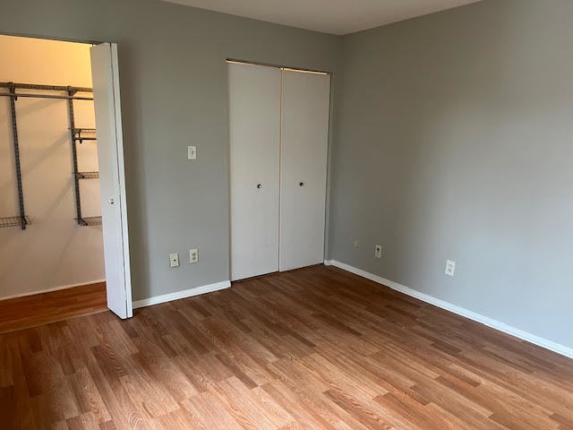 20206 South Frankfort Square Road, Unit K Frankfort, IL 60423 - Photo 11 of 30 a view of an empty room with wooden floor and a window