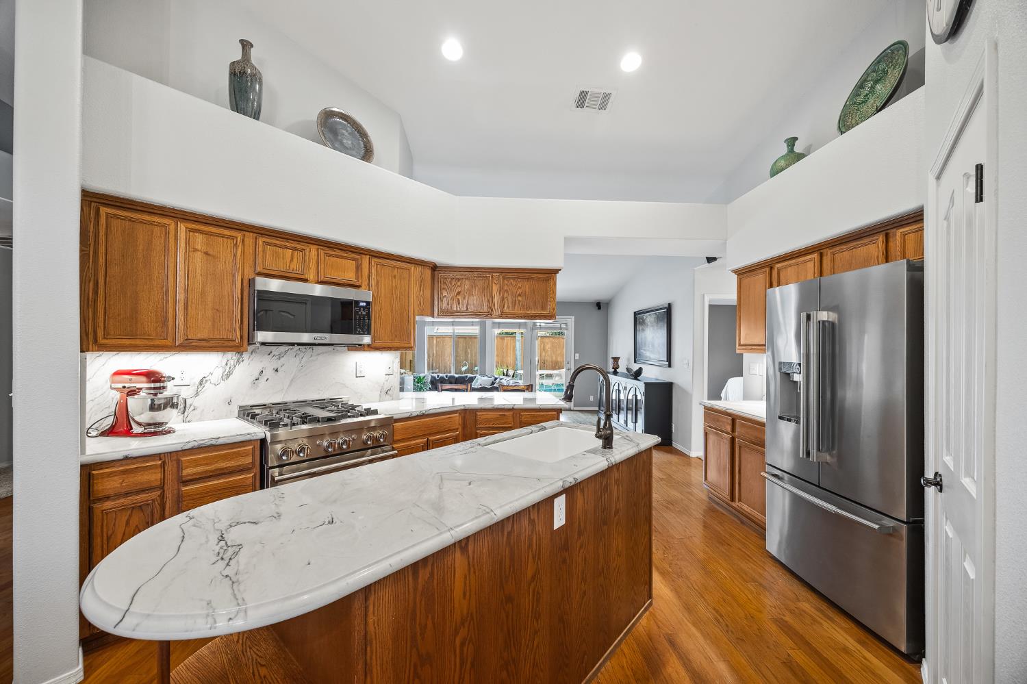161 Sunset Street Kingsburg, CA 93631 - Photo 11 of 57 a kitchen with stainless steel appliances granite countertop a refrigerator stove microwave and sink