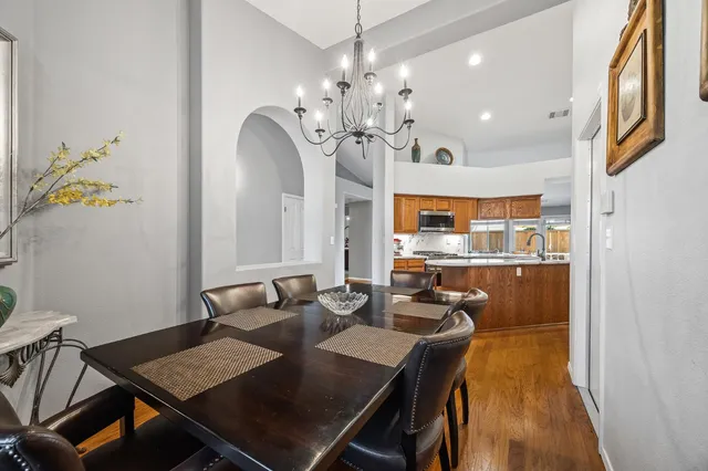 a kitchen with a refrigerator and a stove top oven