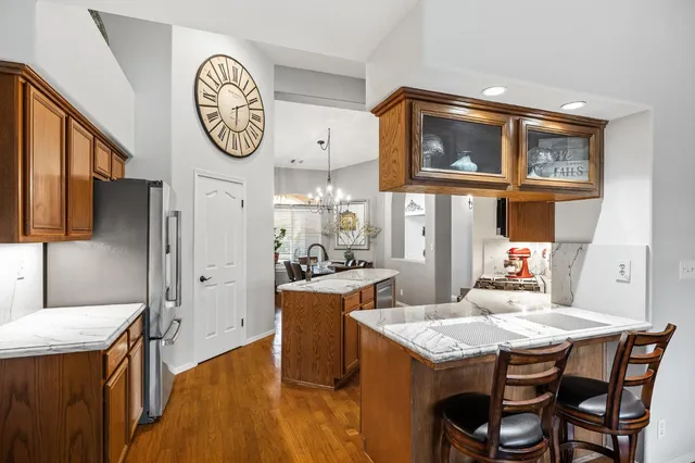 a bathroom with a granite countertop sink a mirror and shower