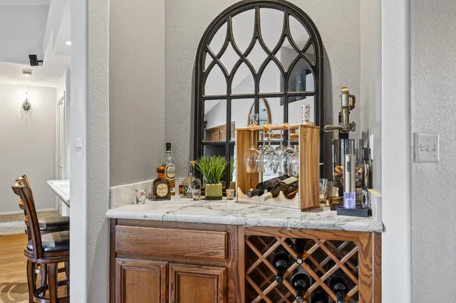 a living room with furniture a rug and a chandelier