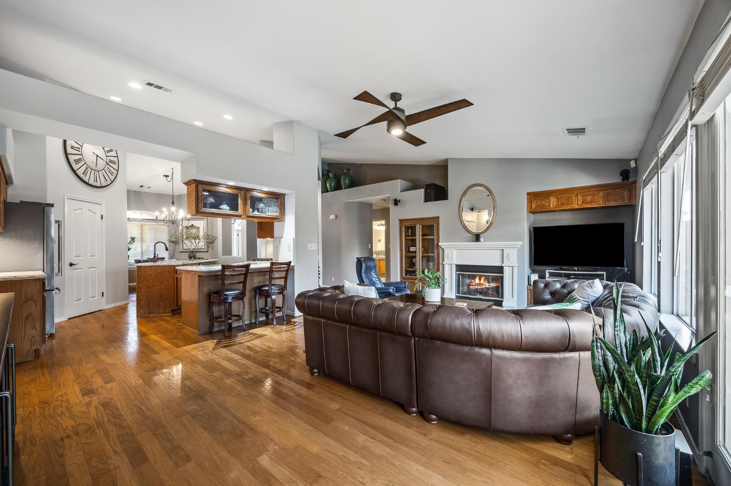161 Sunset Street Kingsburg, CA 93631 - Photo 21 of 57 a living room with furniture a flat screen tv and a fireplace