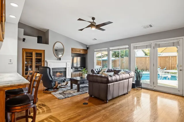 a living room with furniture a fireplace and a flat screen tv