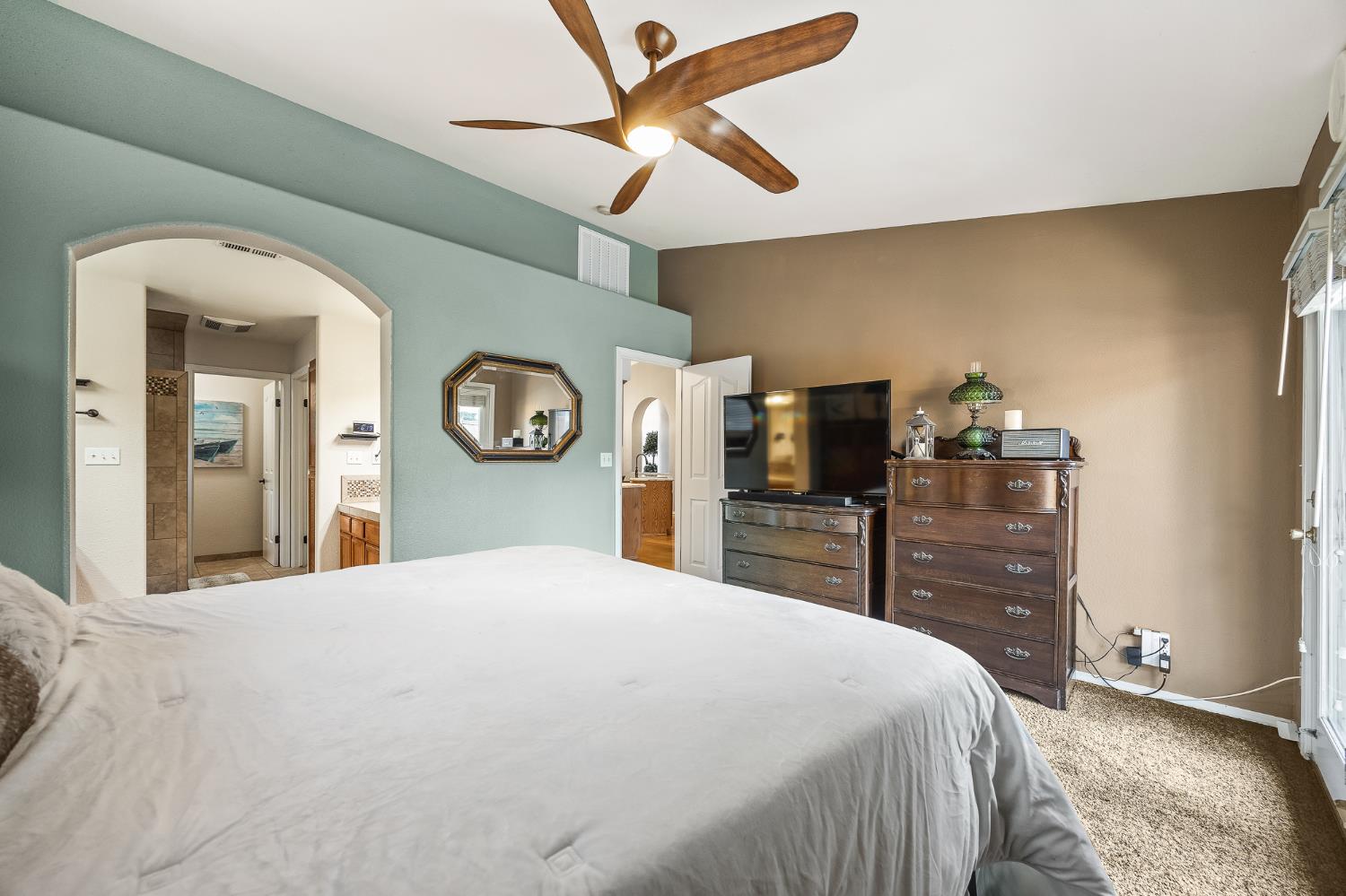 161 Sunset Street Kingsburg, CA 93631 - Photo 26 of 57 a bedroom with a bed and a chandelier