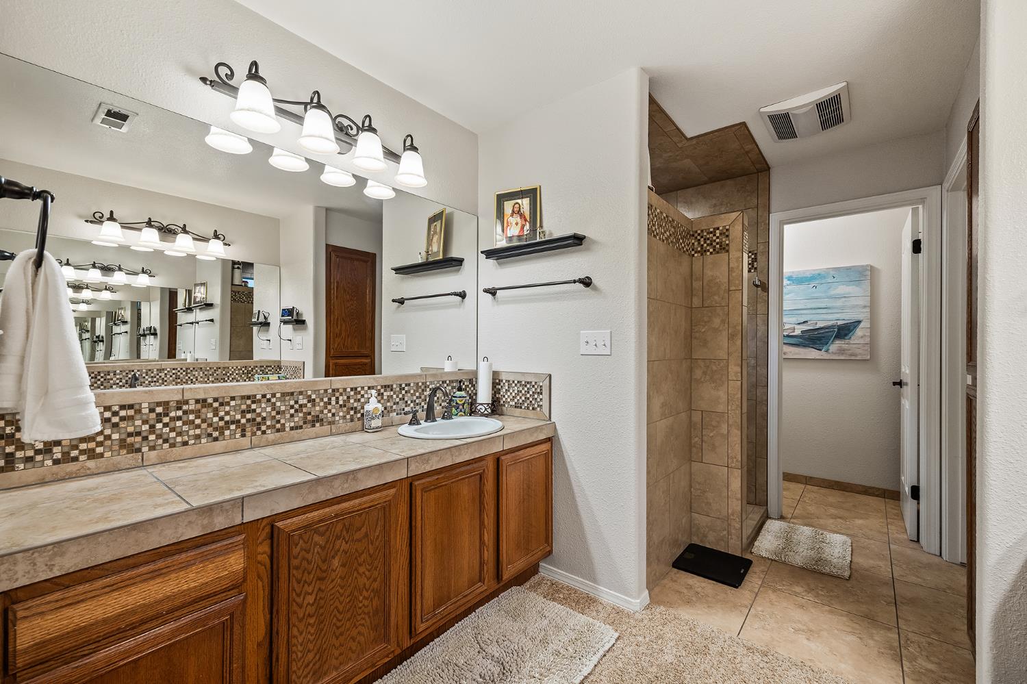 161 Sunset Street Kingsburg, CA 93631 - Photo 28 of 57 a bathroom with a sink vanity and a mirror