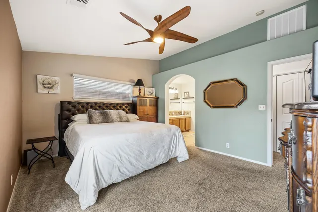 a spacious bathroom with a granite countertop sink a mirror and shower