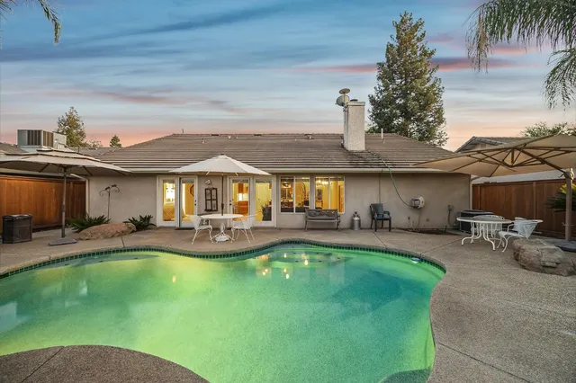 a front view of house with a garden