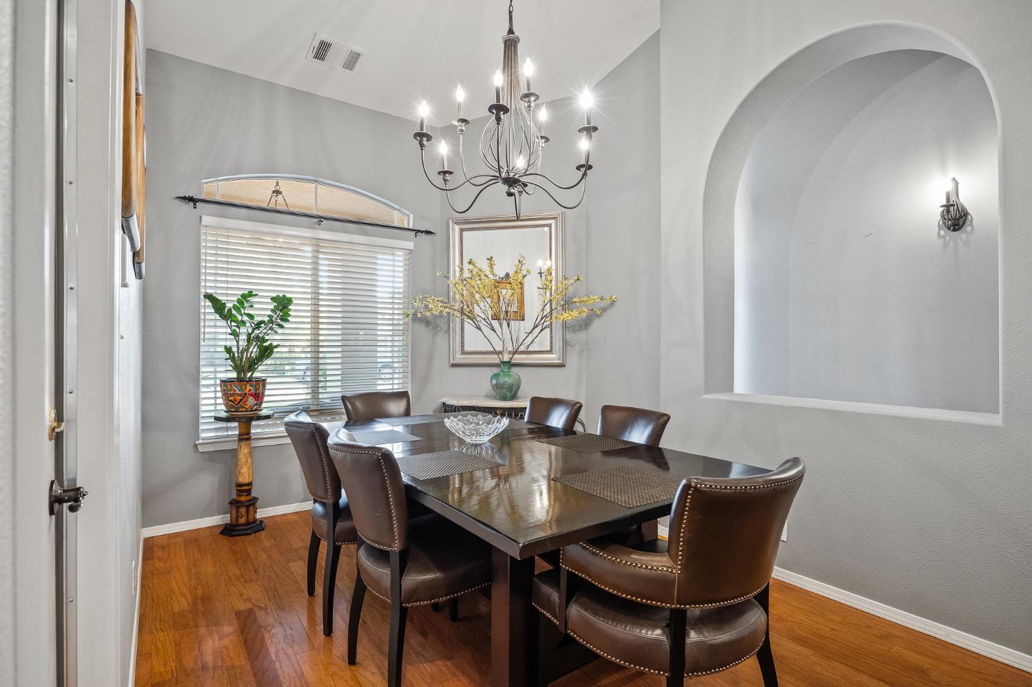 161 Sunset Street Kingsburg, CA 93631 - Photo 9 of 57 a view of a dining room with furniture a chandelier and wooden floor