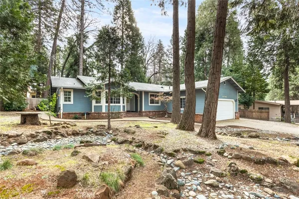 a view of a house with a tree in the background