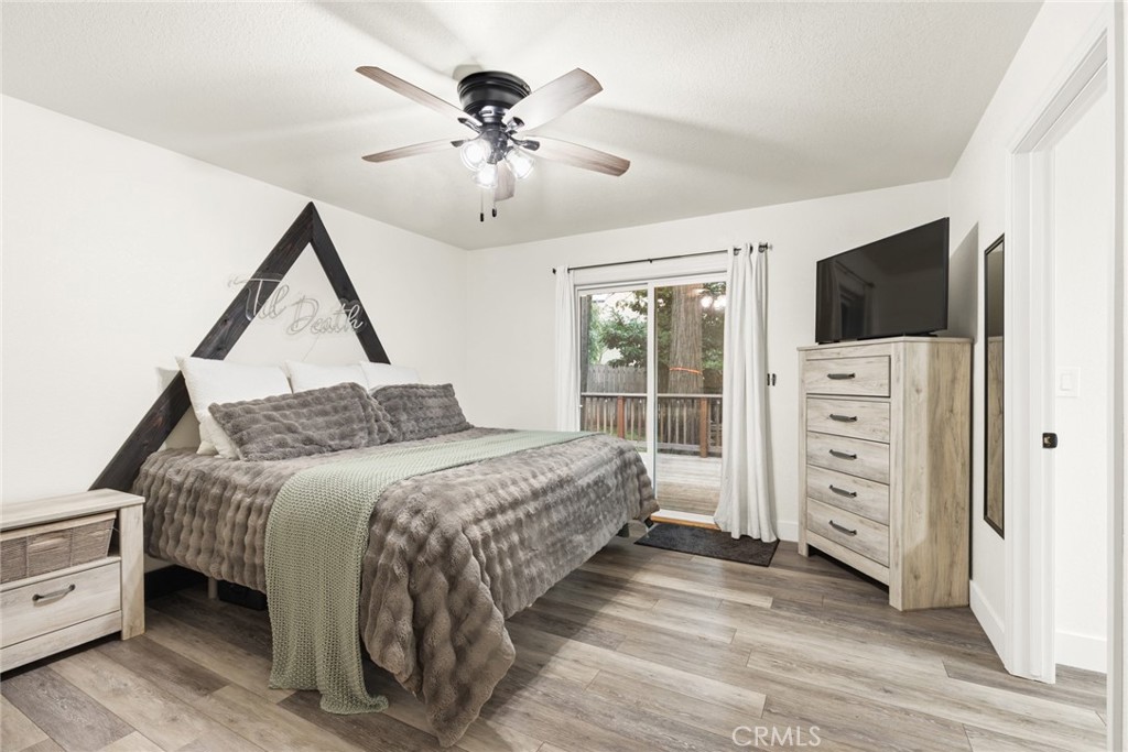 14366 Carnegie Road Magalia, CA 95954 - Photo 11 of 28 a bedroom with a large bed and a flat tv screen on dresser