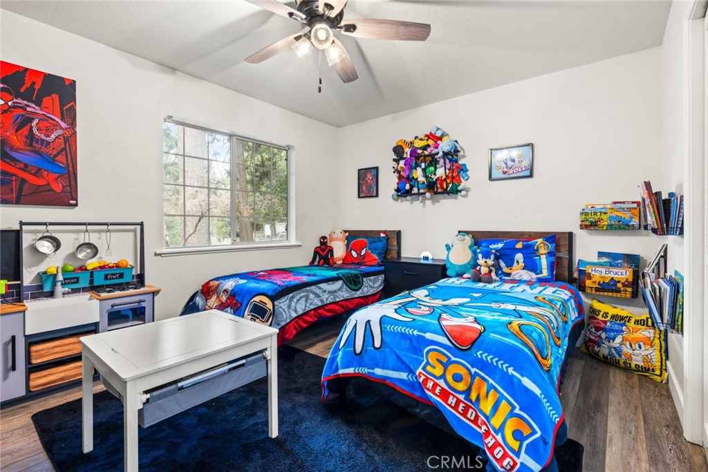 14366 Carnegie Road Magalia, CA 95954 - Photo 13 of 28 a bedroom with a bed a dresser and a book shelf