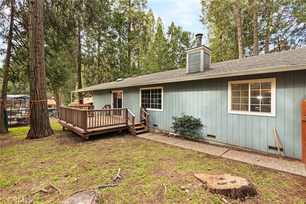 14366 Carnegie Road Magalia, CA 95954 - Photo 22 of 28 a view of a house with a wooden deck and a yard