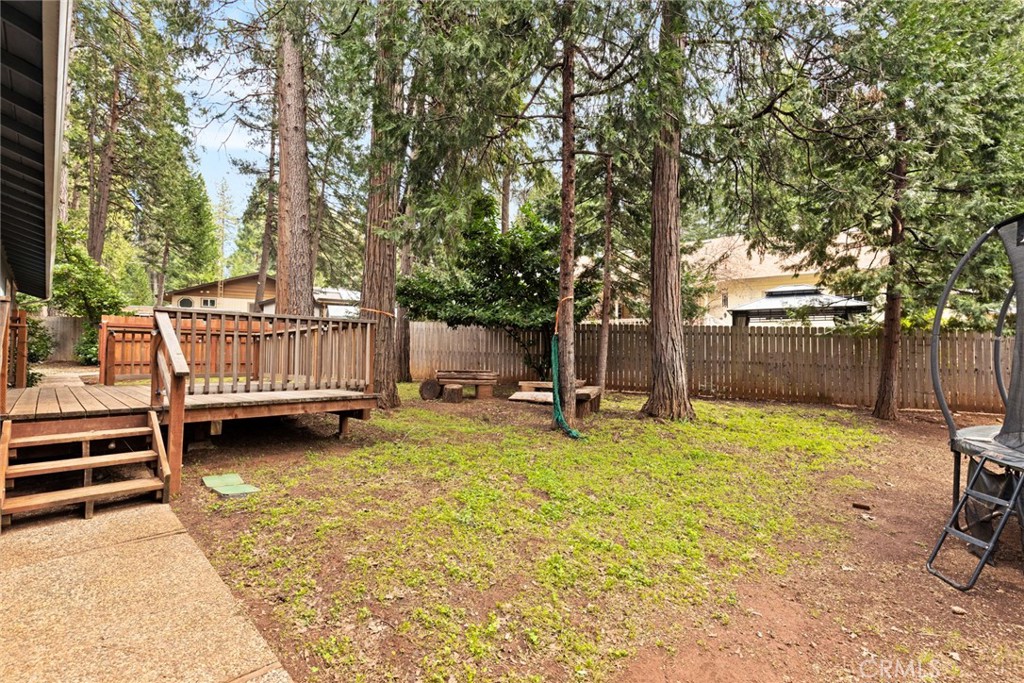 14366 Carnegie Road Magalia, CA 95954 - Photo 26 of 28 a view of backyard with wooden fence and a large tree