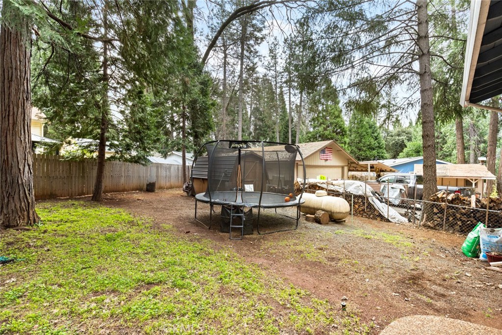 14366 Carnegie Road Magalia, CA 95954 - Photo 27 of 28 a view of a backyard with table and chairs and a fire pit