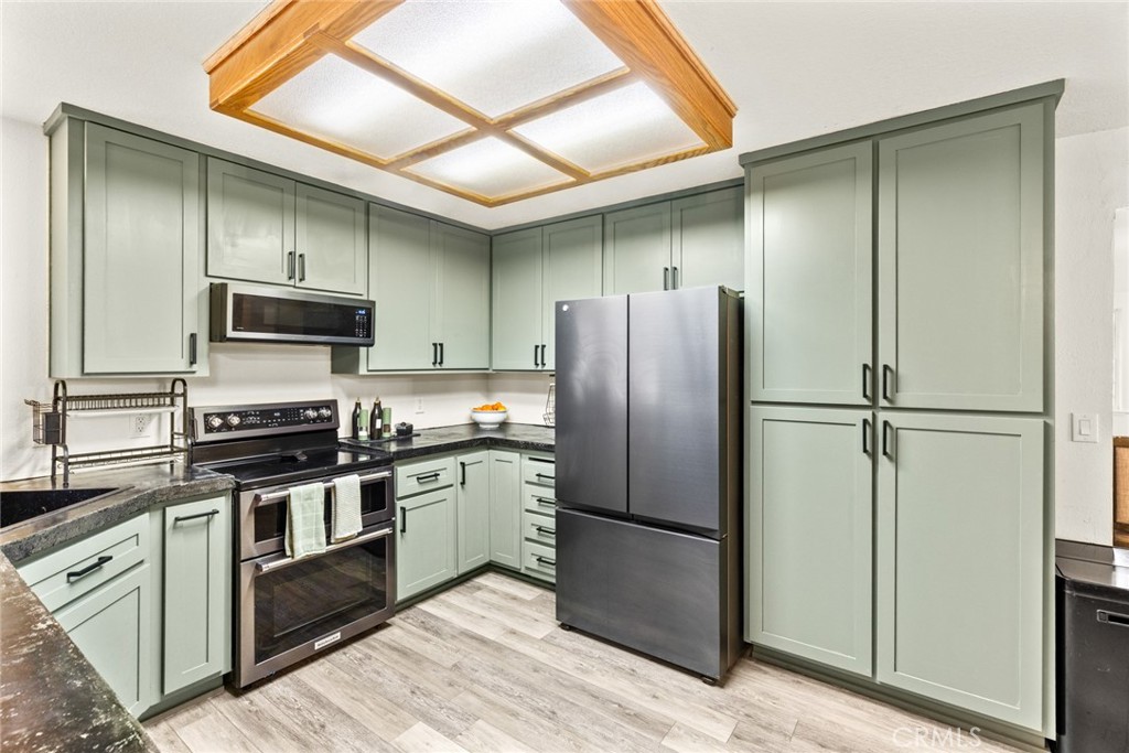 14366 Carnegie Road Magalia, CA 95954 - Photo 10 of 28 a kitchen with stainless steel appliances granite countertop a refrigerator and a stove top oven