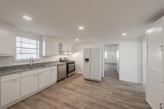 a kitchen with a sink and refrigerator