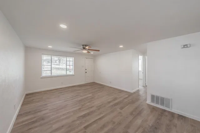 wooden floor in an empty room with a window