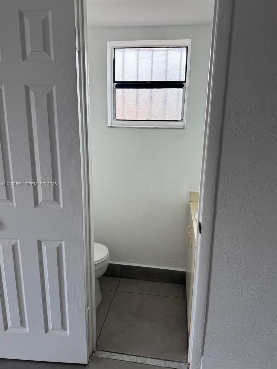 2291 West 53rd Place, Unit 2291 Hialeah, FL 33016 - Photo 6 of 11 a bathroom with a toilet