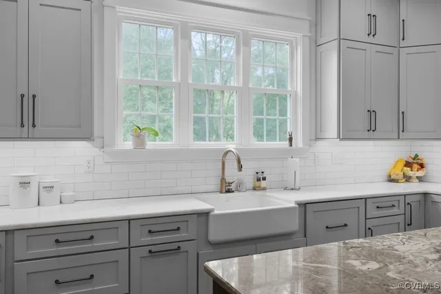 a kitchen with a refrigerator and white cabinets