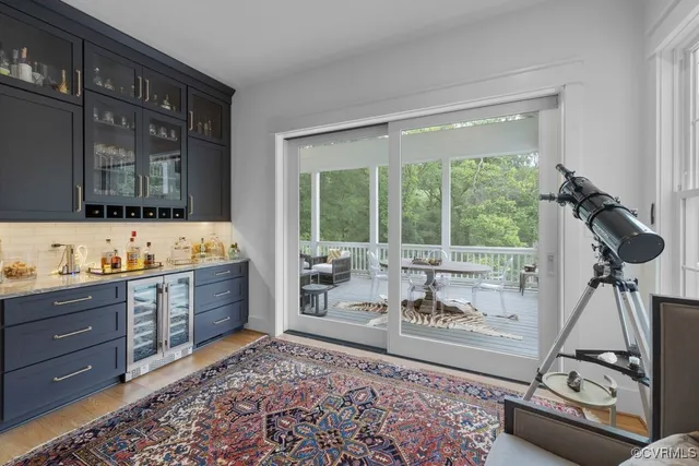 a living room with furniture fireplace and a large window