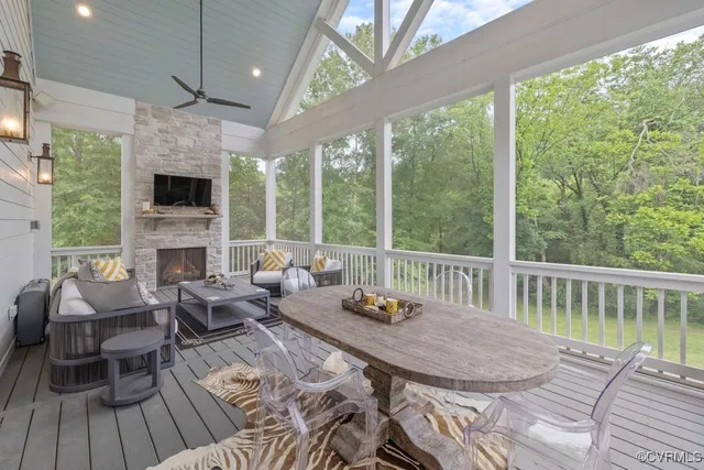 a view of a patio with couches chairs with wooden floor